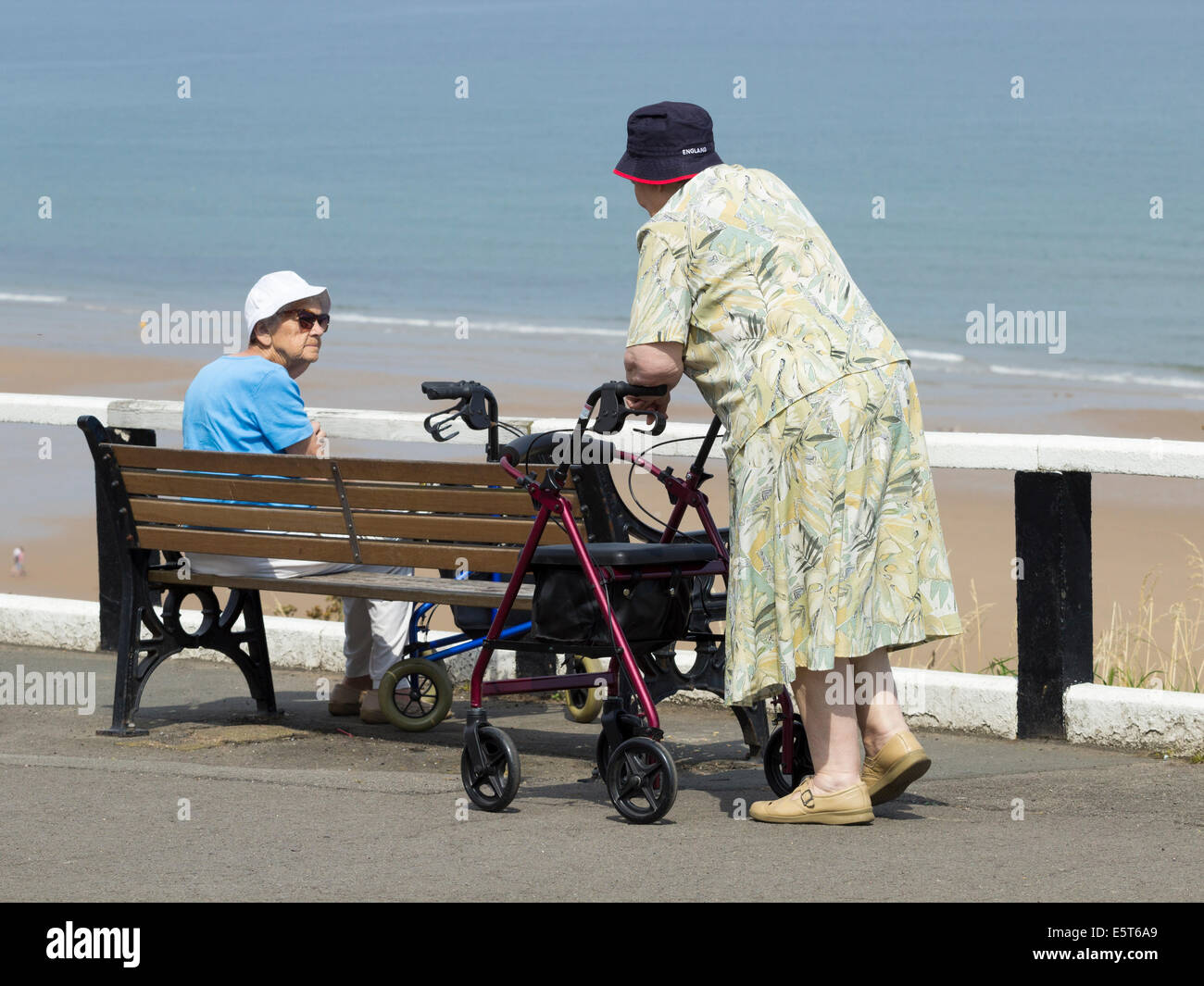 Elderly people at the coast on a warm summer`s day Stock Photo